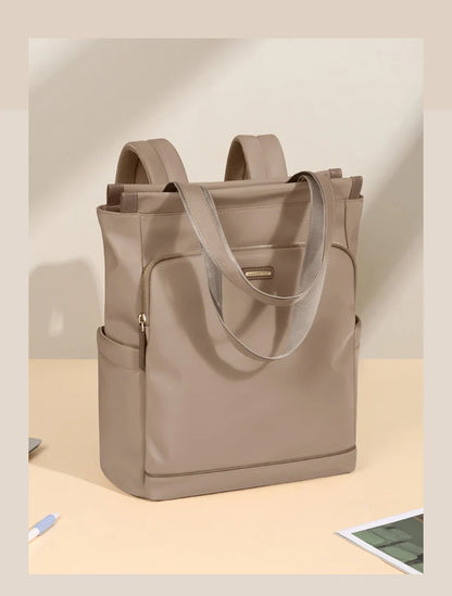 Beige tote bag with shoulder straps on a light beige background