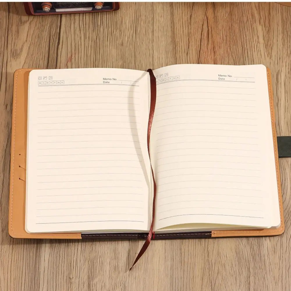 Open notebook with lined pages on a wooden surface