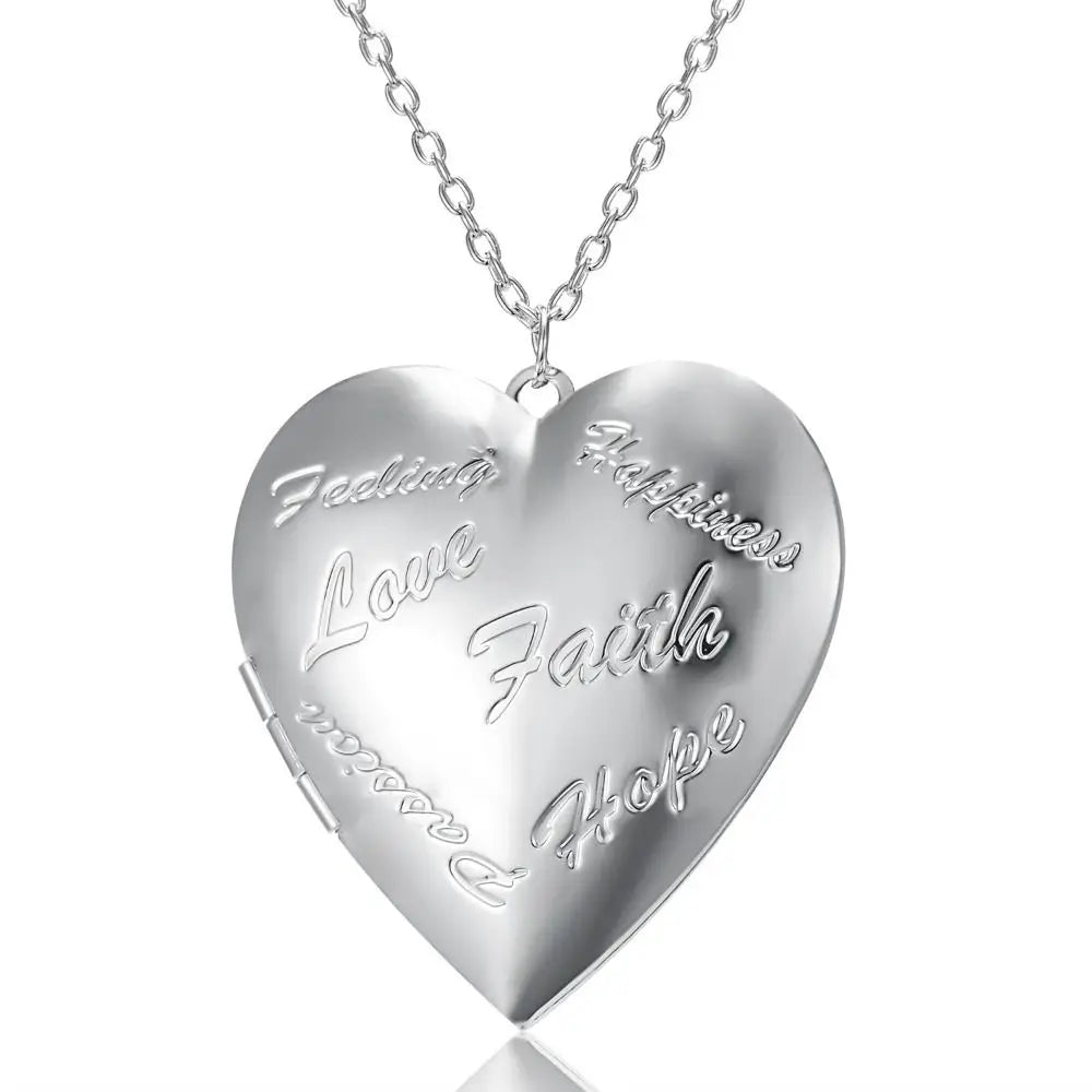 Silver heart-shaped locket with engraved words on a white background