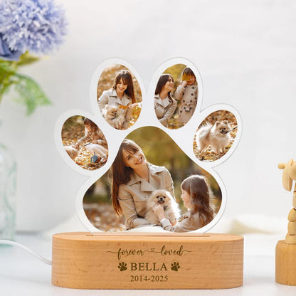 Paw-shaped photo collage with a wooden base displaying 'forever loved BELLA 2014-2025' on a light background.