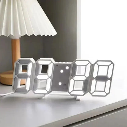 Digital clock on a surface with a lamp in the background