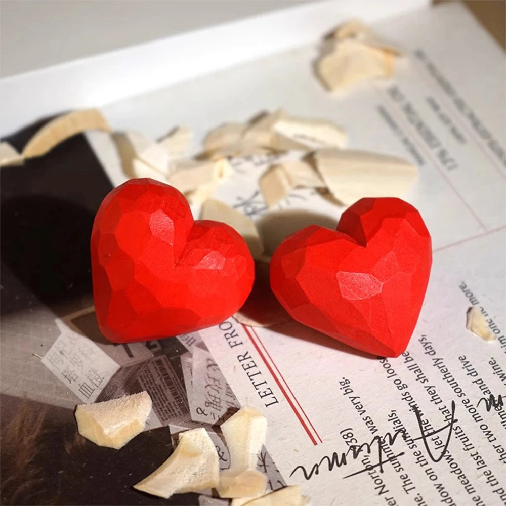 Red heart-shaped earrings on a newspaper background