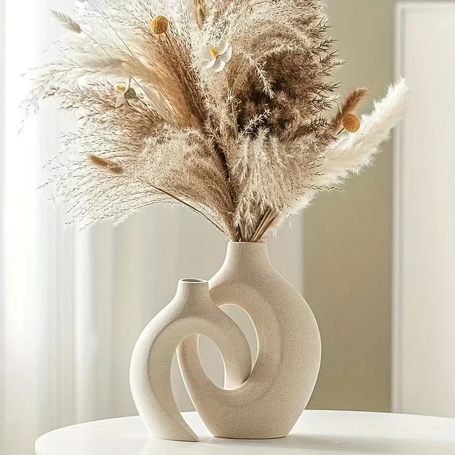 Decorative vase with dried pampas grass against a neutral background