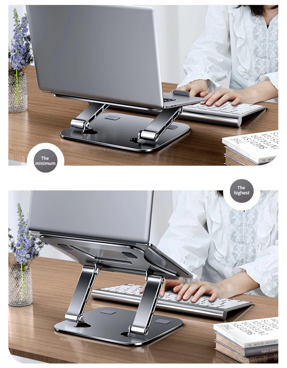 Laptop stand being used by a person at a desk with a laptop and keyboard.