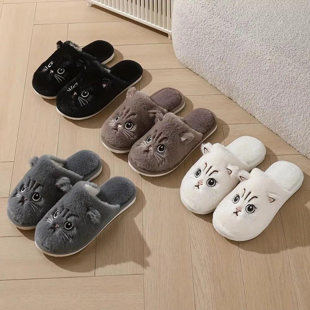 Set of cat-themed slippers in black, brown, gray, and white on a wooden floor.