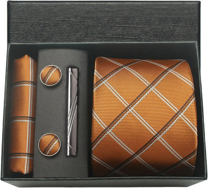Men's accessory set with tie, pocket square, cufflinks, and pen in a black box.