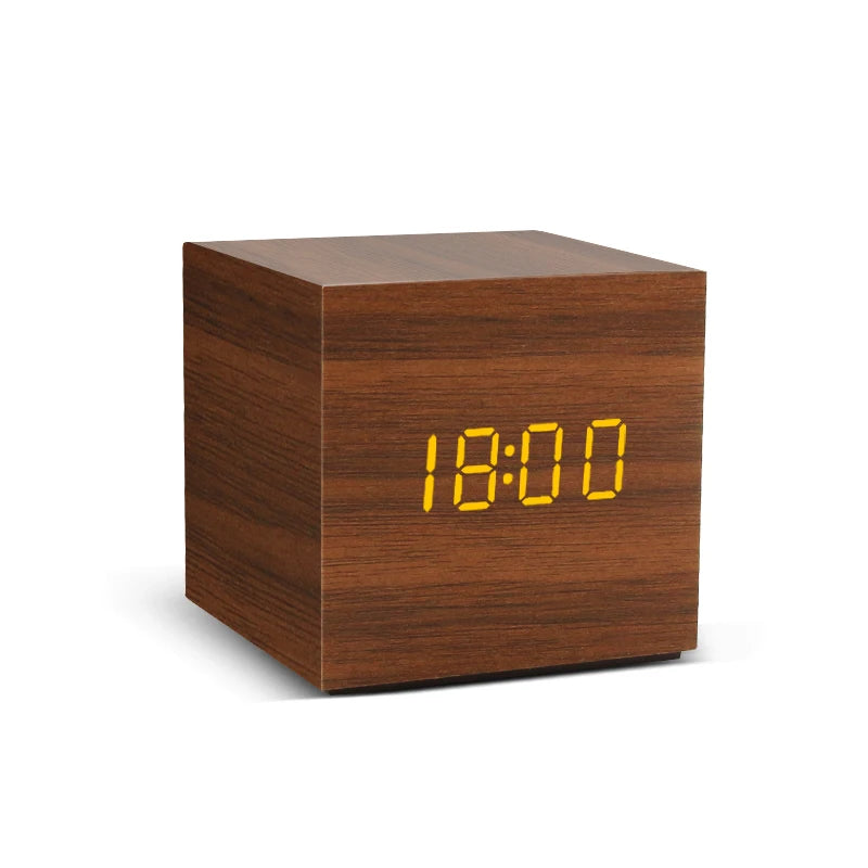 Wooden cube clock with digital display on a white background