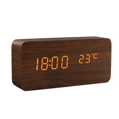 Wooden digital clock with LED display on a white background