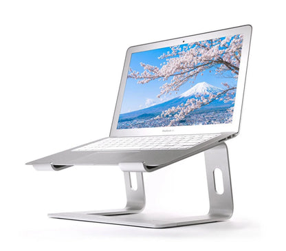 Laptop on a stand with a scenic display of cherry blossoms and Mount Fuji.