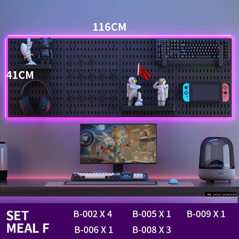 Gaming setup with monitor, keyboard, and other peripherals on a desk with a wall-mounted pegboard.