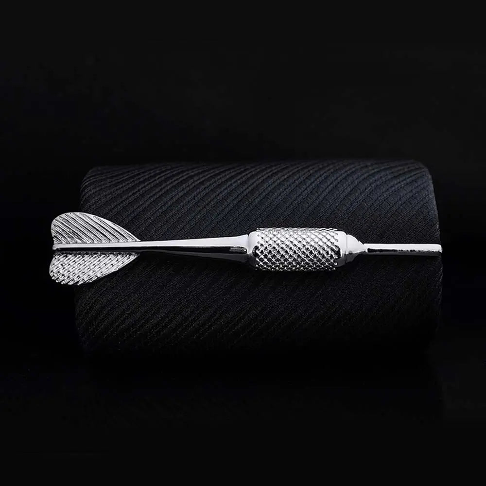 Silver dart on a black textured surface