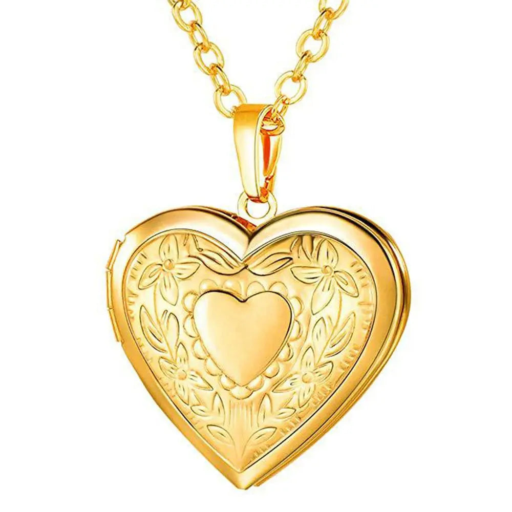 Gold heart-shaped locket on a chain against a white background