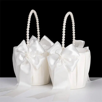 Set of white gift bags with pearl handles on a black background