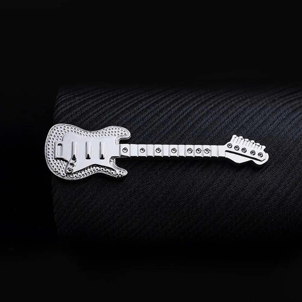 Metallic guitar-shaped object on a textured black background