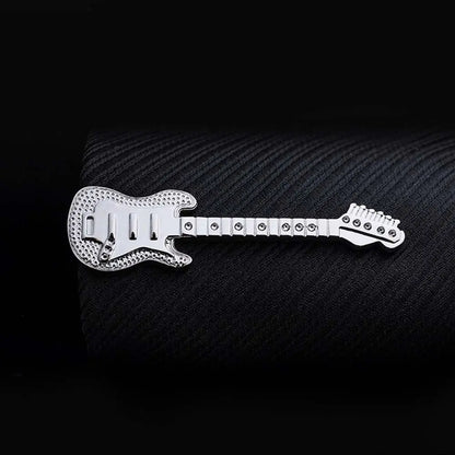 Metallic guitar-shaped object on a textured black background