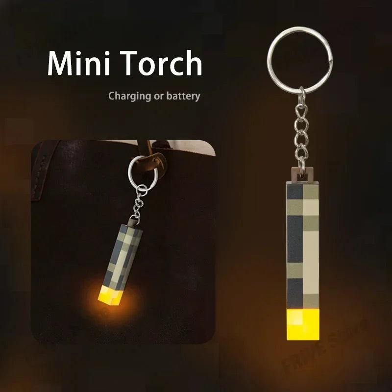 Mini torch keychain with glowing end on a dark background