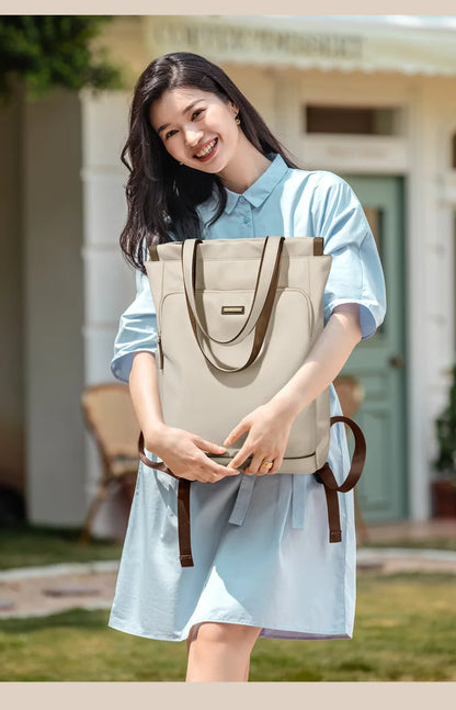 Woman holding a beige tote bag outdoors