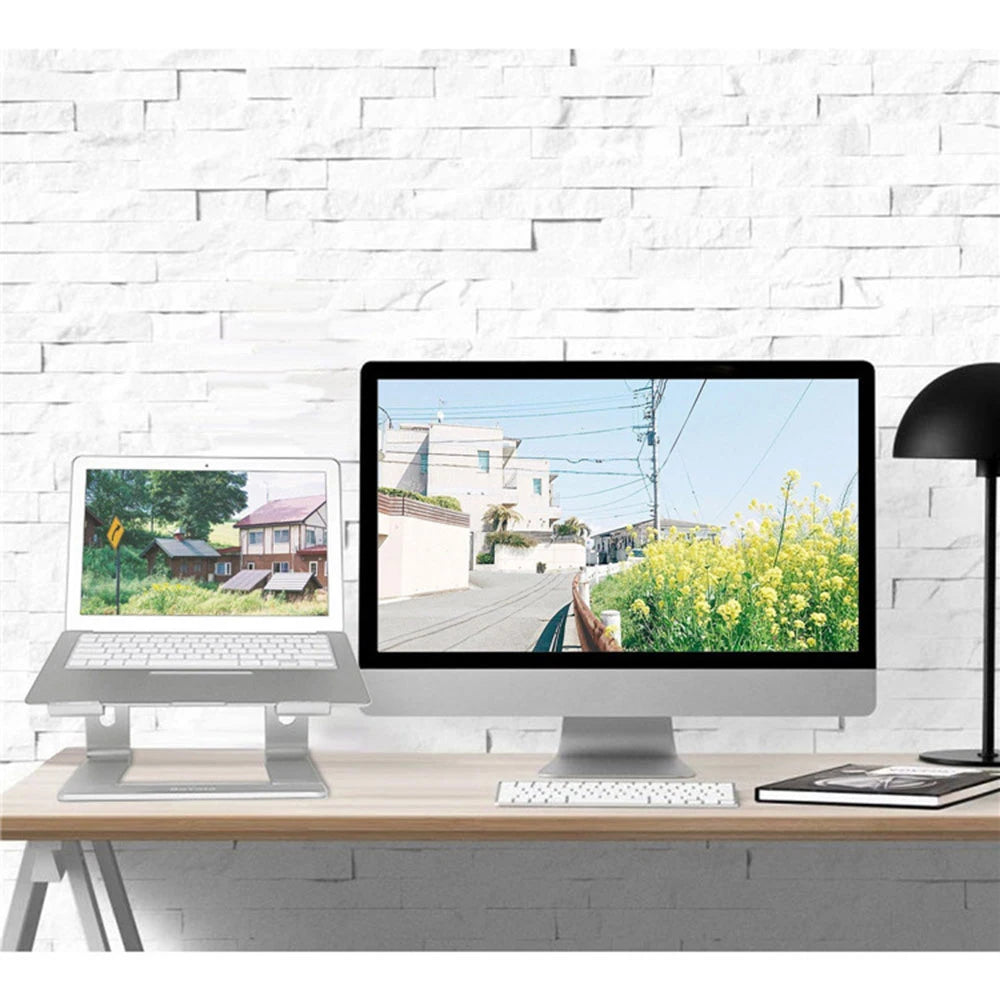Two computer monitors on a desk with a white brick wall background