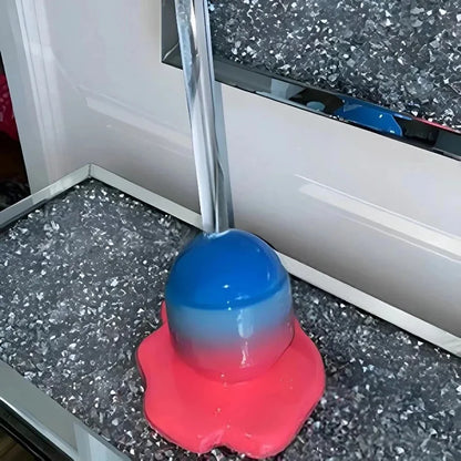 Blue and red object on a speckled floor with a white baseboard in the background