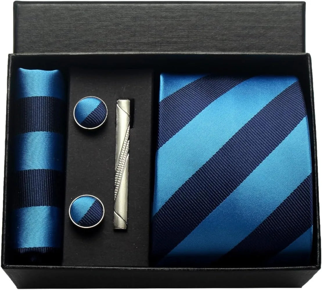 Blue striped tie set with matching pocket square, cufflinks, and tie clip in a black box.