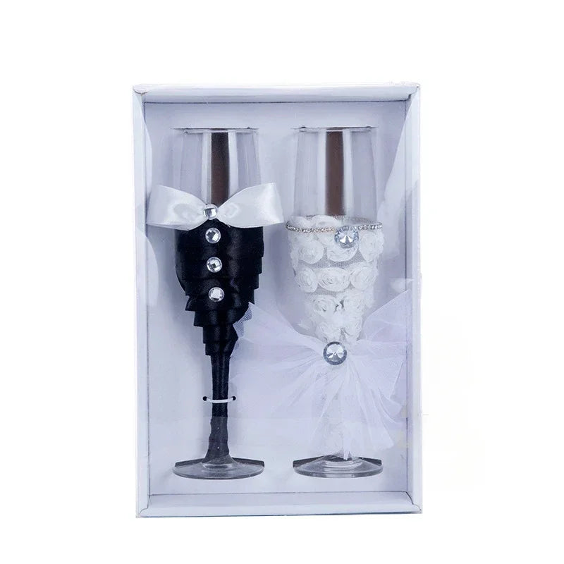 Two decorative wine glasses, one black and one white, in a box on a white background