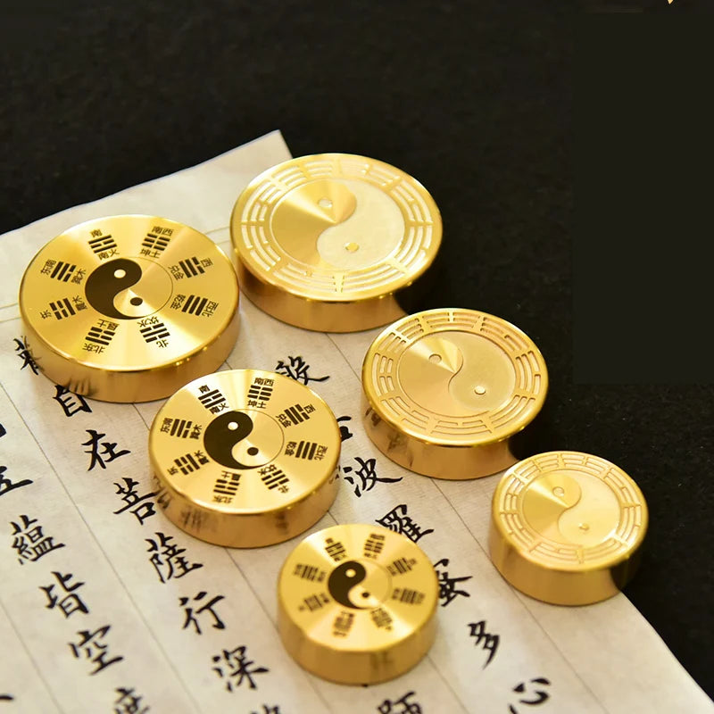 Gold coins with yin yang symbol on a piece of paper with Chinese characters
