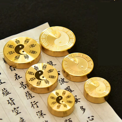 Gold coins with yin yang symbol on a piece of paper with Chinese characters