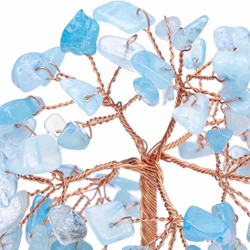 Decorative tree made of blue stones and copper wire on a white background