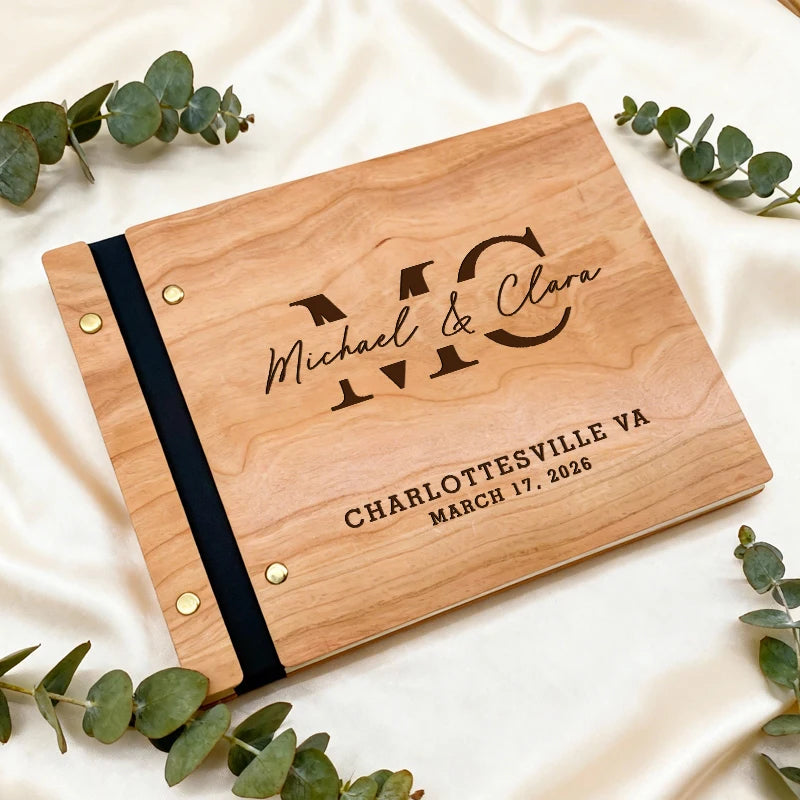 Wooden photo album with engraved text on a white fabric background
