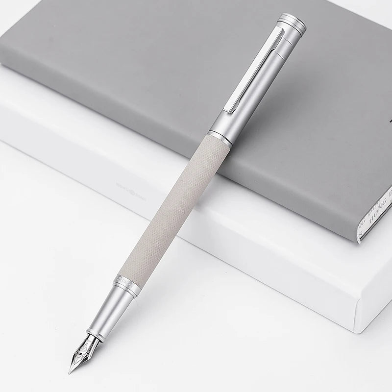 Silver pen with textured grip on a white surface