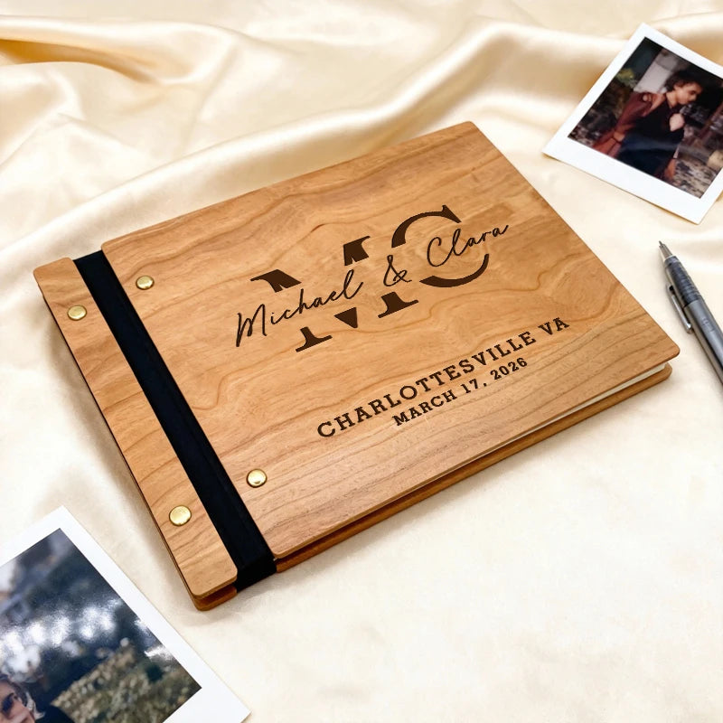 Wooden photo album with engraved text on a beige fabric background