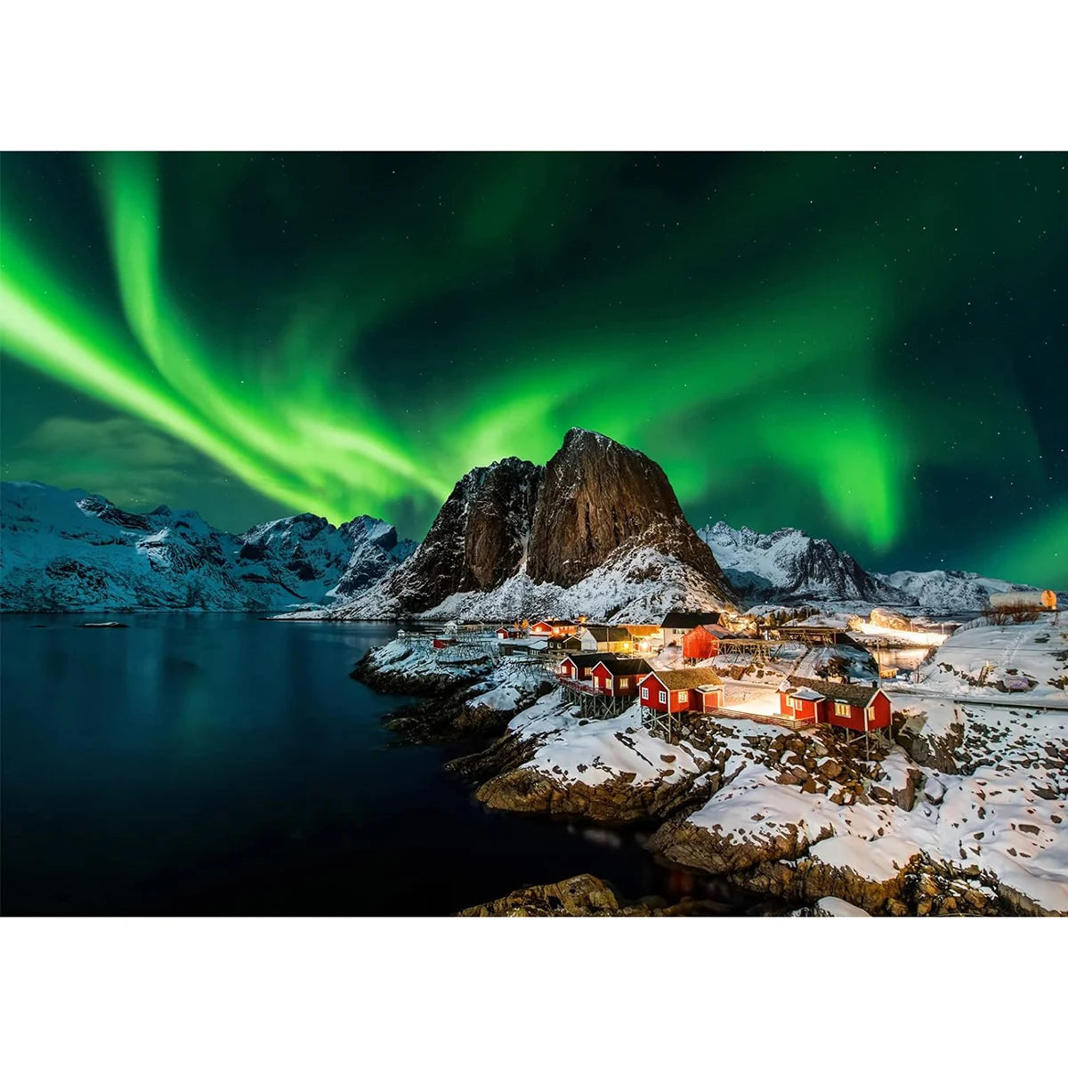 Northern lights over a snowy landscape with red cabins and mountains.