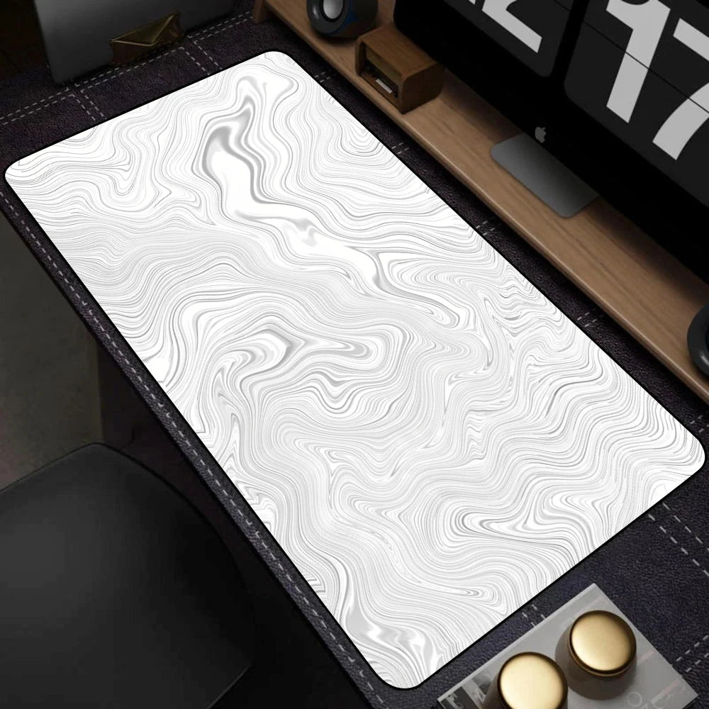 White desk mat with wavy pattern on a dark surface