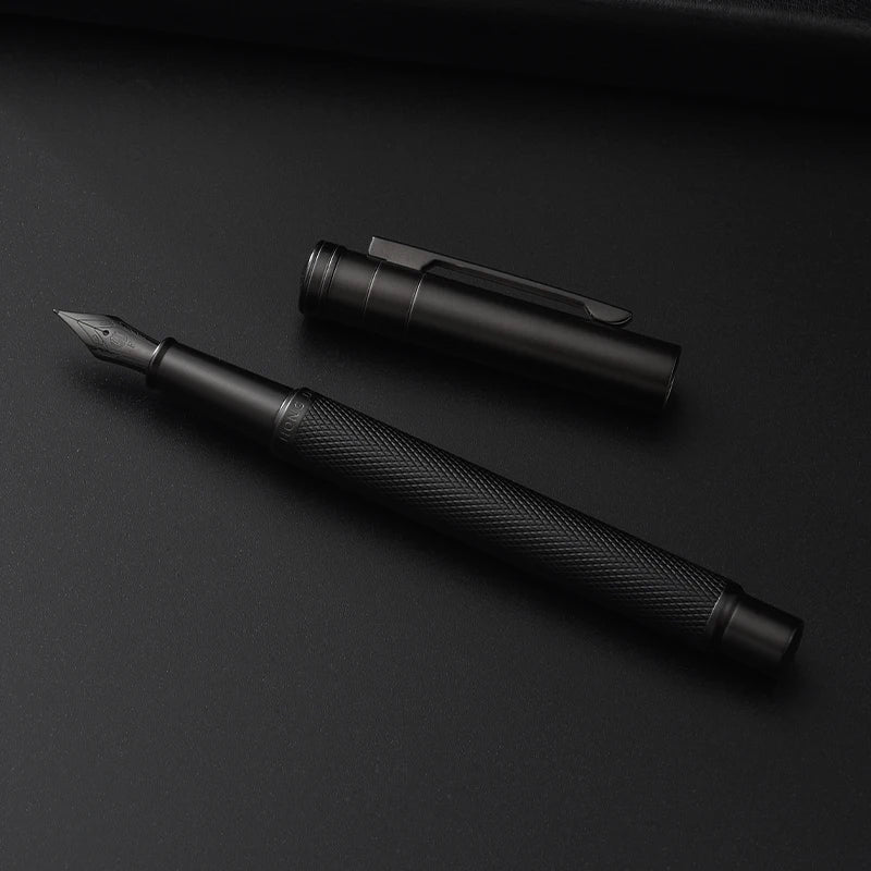 Black fountain pen and cap on a black background