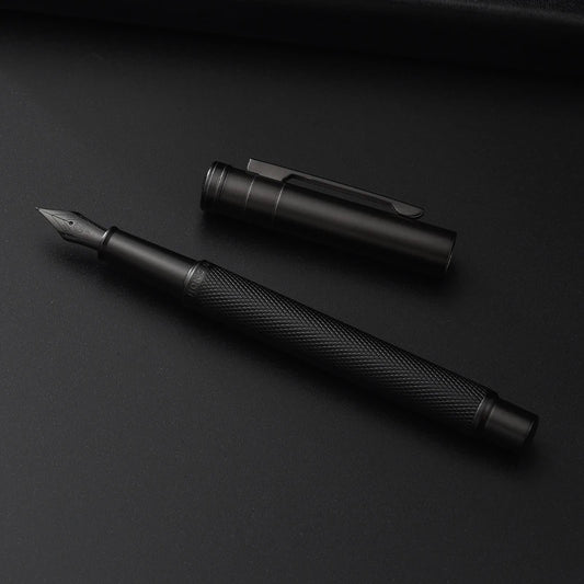 Black fountain pen and cap on a black background