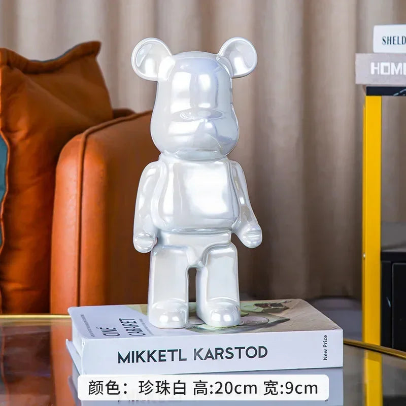 Clear bear-shaped decorative object on books with a blurred background