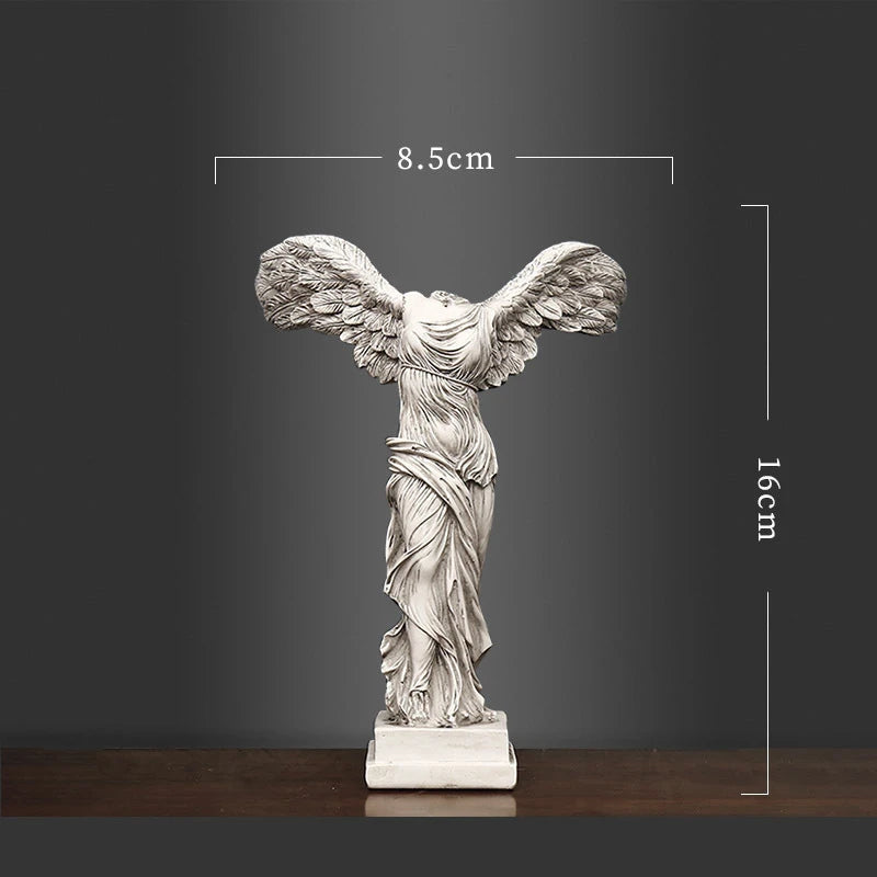 Statue of a winged figure with dimensions indicated on a dark background