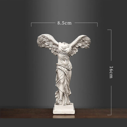 Statue of a winged figure with dimensions indicated on a dark background