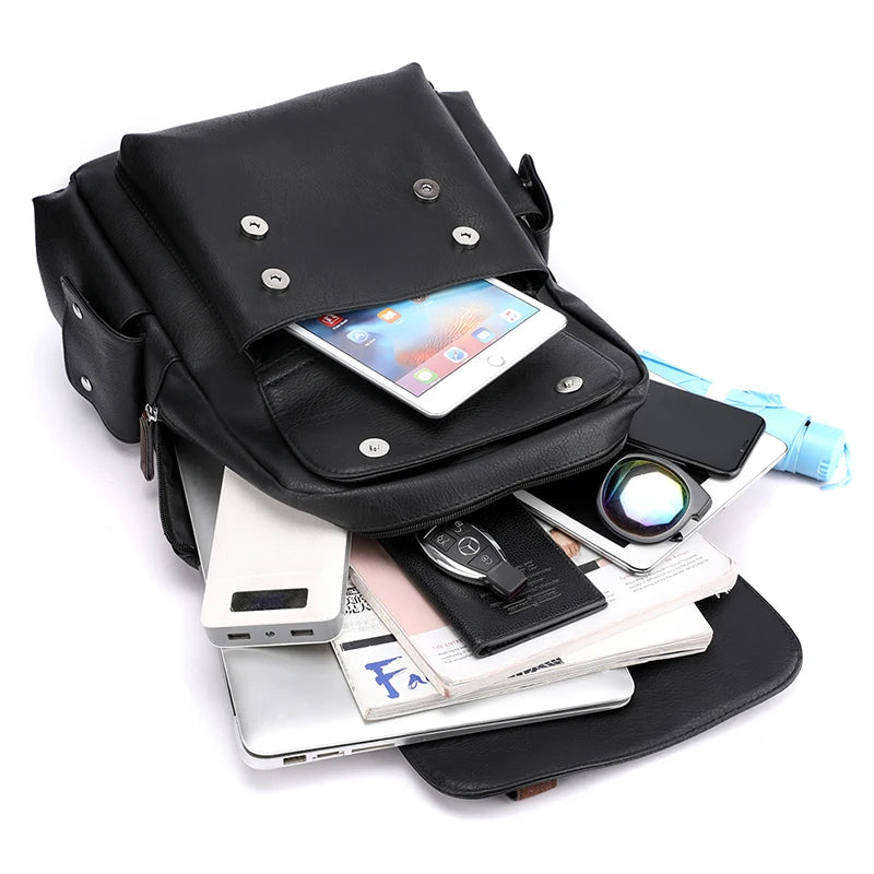 Black leather bag with various items including a phone, wallet, and power bank on a white background
