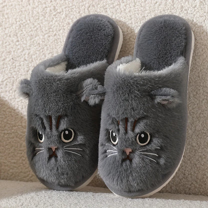 Gray cat-shaped slippers on a textured surface