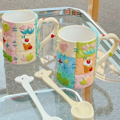 Two colorful mugs with decorative patterns on a glass surface.