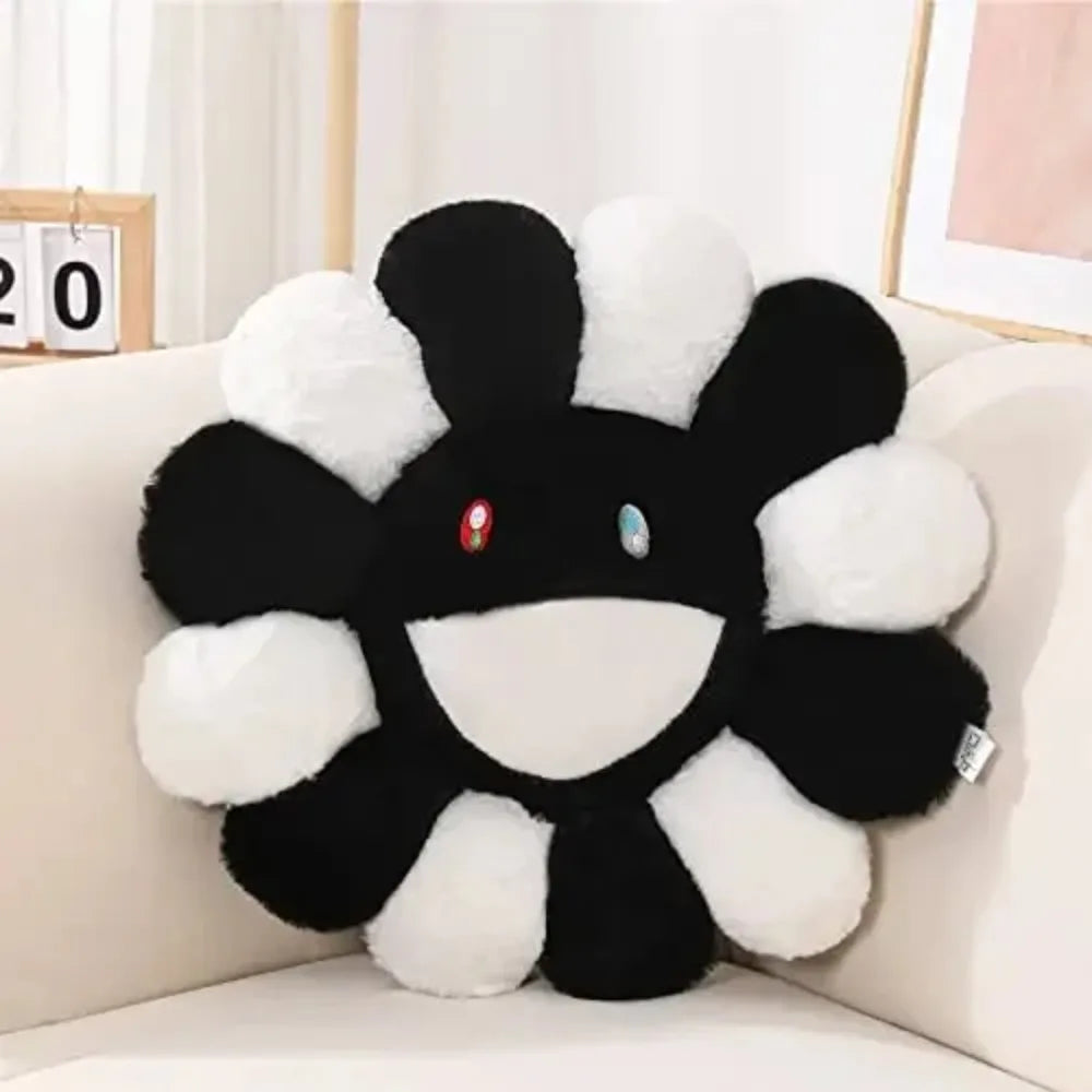 Black and white plush toy resembling a character on a beige couch.