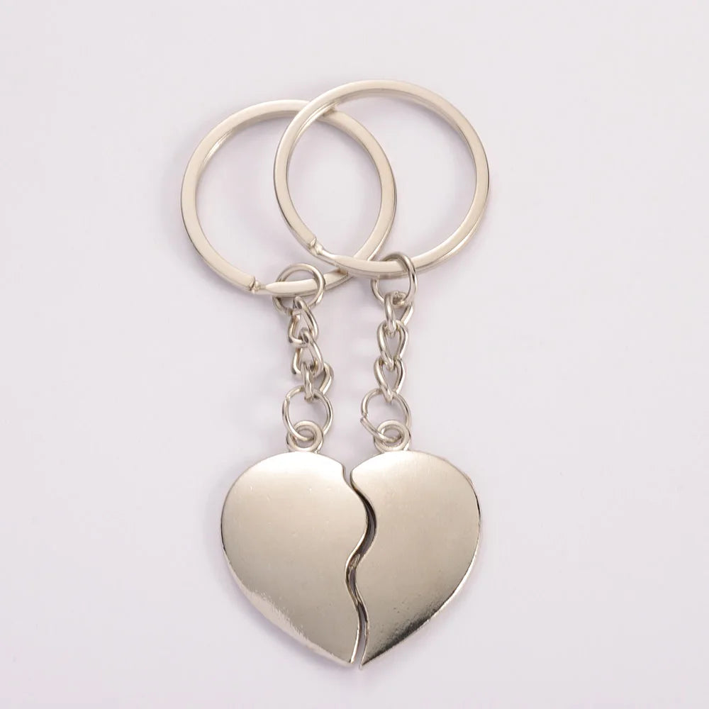 Silver heart-shaped keychain with a split design on a white background