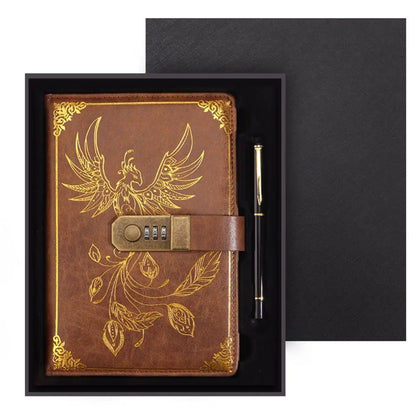 Brown leather notebook with gold embossed design and pen in a black box
