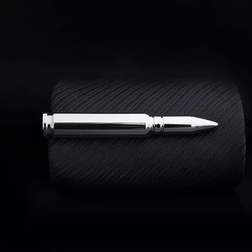 Metallic pen on a textured black surface with a dark background