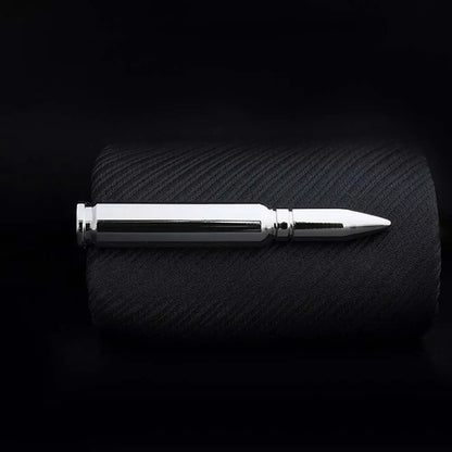 Metallic pen on a textured black surface with a dark background