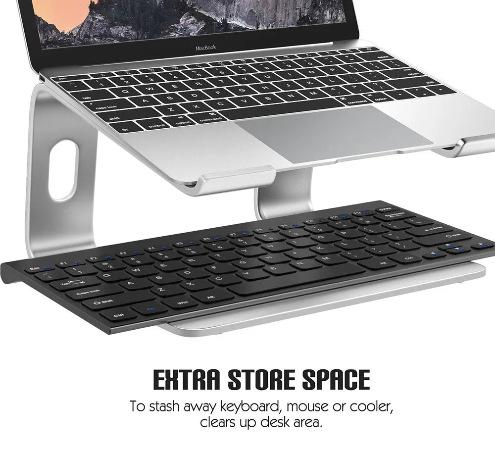 Laptop on a stand with an additional keyboard, mouse, and cooler on a white background.