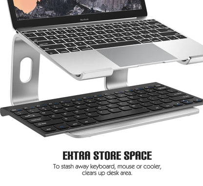 Laptop on a stand with an additional keyboard, mouse, and cooler on a white background.
