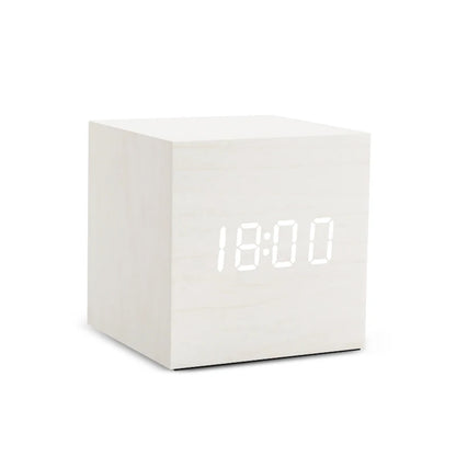 White digital clock with LED display on a white background