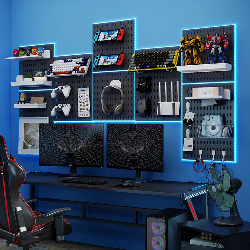 Gaming setup with monitors, chair, and shelves against a blue wall.